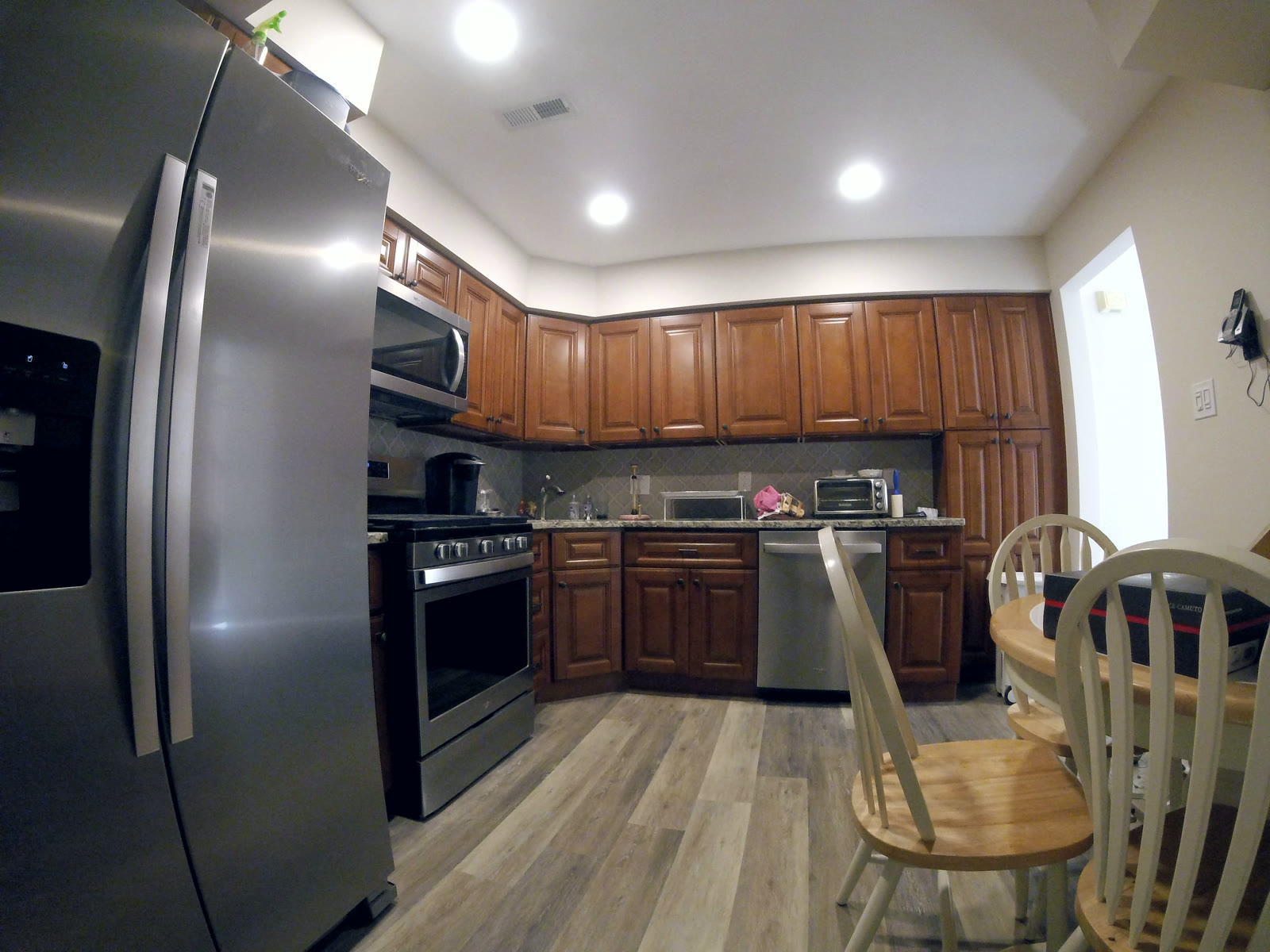 Kitchen remodel with cherry cabinets, granite counters, and stainless appliances — The Remediation Tech