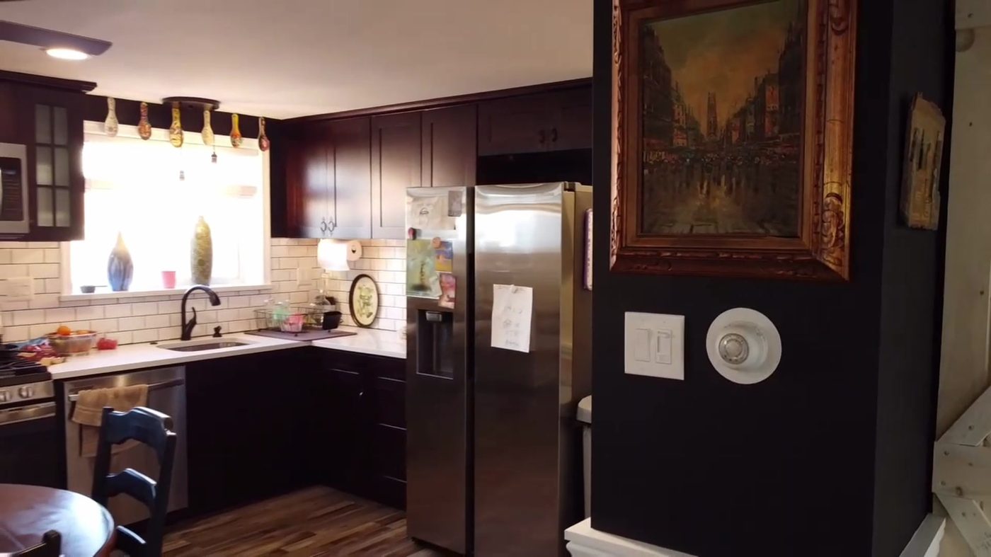 Mayfair kitchen remodel with cherry shaker cabinets, white counters, subway-tile backsplash, and black faucet — The Remediation Tech