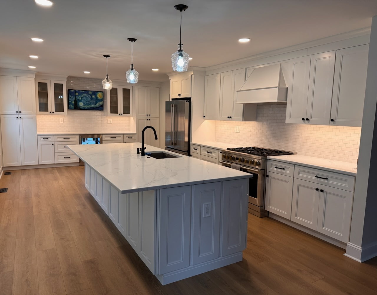 Kitchen remodel with white shaker cabinets, quartz island, and subway-tile backsplash — The Remediation Tech